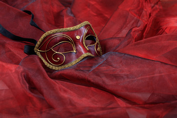 Carnival mask on red background, copy space