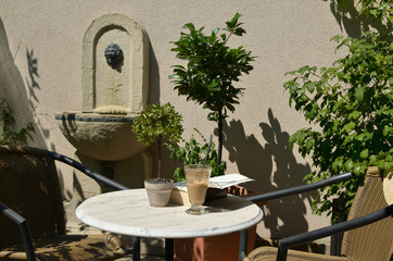 Book and glass of coffee on a table in cafe bar