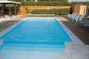 Swimming pool with chair at hotel close up