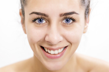 Obraz premium Beautiful happy young woman with deep blue color of eyes