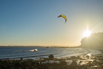 Kitesurfing at sunrise. North Beach, Port Townsend, Washington.