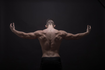 Fototapeta na wymiar young man posing back muscles, rear view