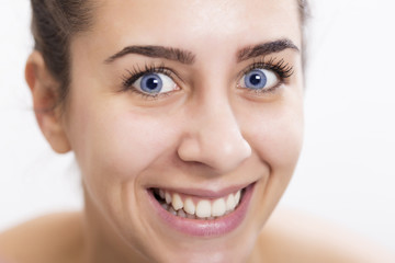 Obraz premium Beautiful happy young woman with deep blue color of eyes