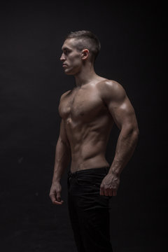young man, bodybuilder posing, side view, profile