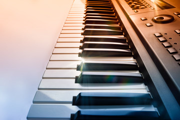 Synthesizer keyboard with shine and blue red gradient side view