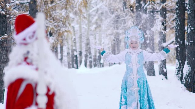 Smiling actors dressed in New Year costumes waving hand to each other