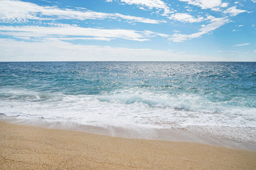 Fototapeta na wymiar Sand, sea and beautiful blue sky with clouds