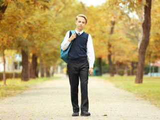 Cute teenager walking along pathway in park
