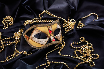 Carnival mask on black satin background