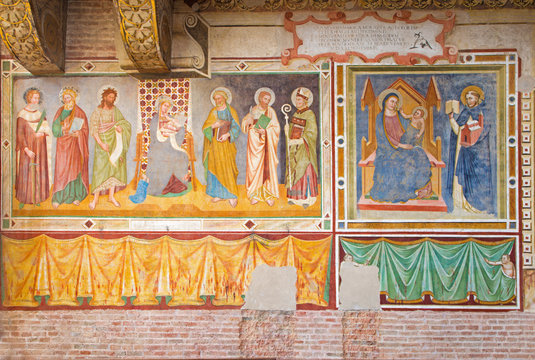 TREVISO, ITALY - MARCH 18, 2014: Fresco of the Madonna and saints in saint Nicholas or San Nicolo church from 14. cent.