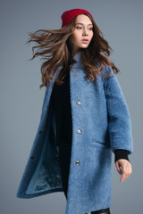 Girl in blue fur coat and red hat