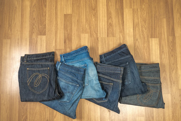 Blue jeans on a brown wooden background and Blue jeans denim Col