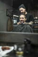 Fototapeta na wymiar Stylish man in barbershop