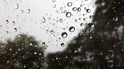 Dark atmosphere rain drops on the other side of the glass. With