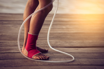 Feet of rope jumping man. Vintage tinted image