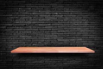Wooden shelf on Black  brick wall background  - can be used for