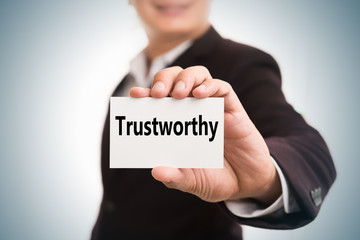 Trustworthy message word on card in hand of Friendly man hand an
