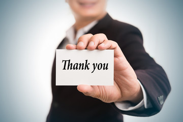 Thank you message word on card in hand of Friendly man hand and