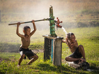 Two young boy rocking groundwater bathe in the hot days, Country