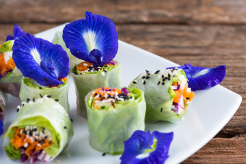 Fresh vegetable noodle spring roll, with butterfly pea flower.