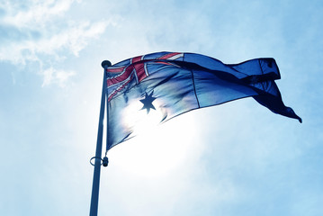 Australia flag waving in blue sky
