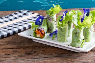 Fresh vegetable noodle spring roll, with butterfly pea flower.