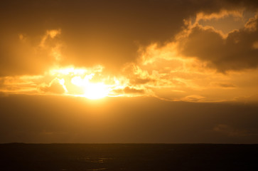 A sunset bathes the sky in a warm, golden glow above Stokes Bay, Kangaroo Island in South Australia