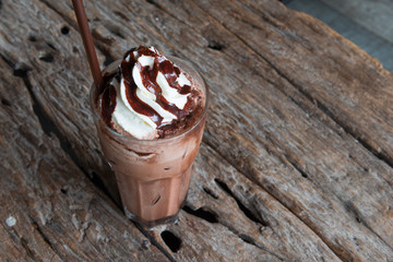 Ice chocolate with whipped cream on table