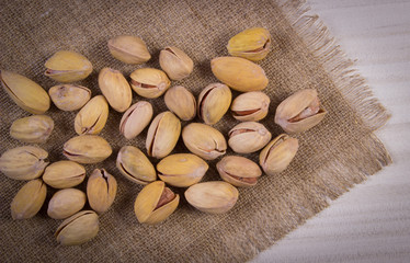 Vintage photo, Pistachio nuts on white wooden table, healthy eating