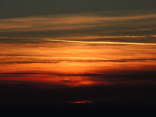 Fiery sunset from Bergamo city to the Padana valley. Lombardy, Italy. Sunset during fall season.