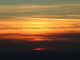 Fiery sunset from Bergamo city to the Padana valley. Lombardy, Italy. Sunset during fall season.