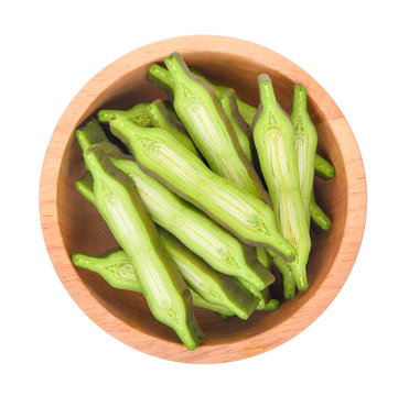 top view of slice Oroxylum indicum in wooden bowl isolated on wh