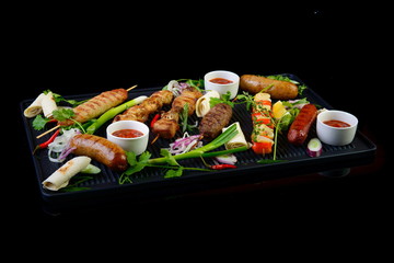 grilled assorted meat on black background