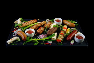 grilled assorted meat on black background