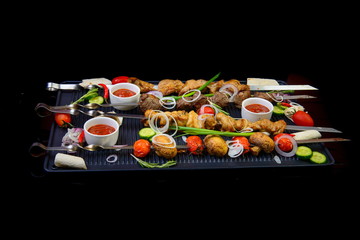 grilled assorted meat on black background