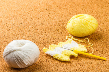 roll of white and yellow soft knitting yarn, knitting, needle