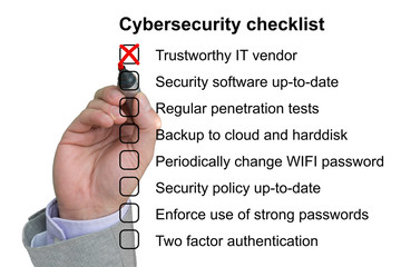 Hand crosses off the first item of a cybersecurity checklist
