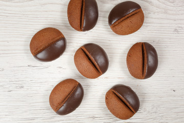 cookie coffee beans on a white wooden background