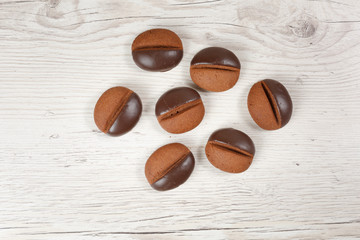 cookie coffee beans on a white wooden background