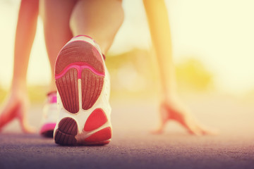 Runner feet running on road closeup on shoe.