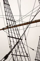 rigging and mast and ropes of a sailing ship up close