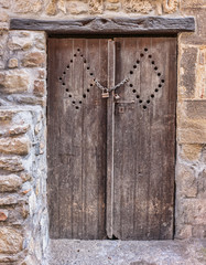 Old wooden door in the entrance stone French house