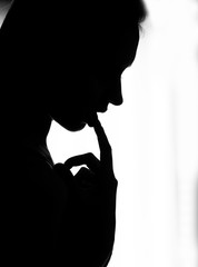 close-up silhouette of the girl put her finger to her lips