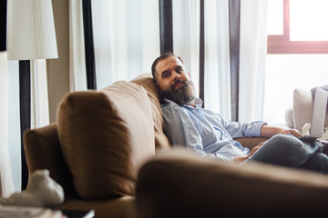 Handsome man with laptop on sofa