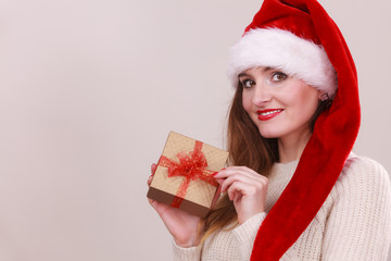 Woman holding gift box. Christmas time