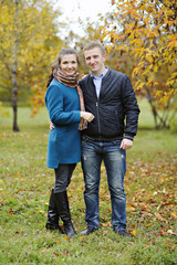 Fototapeta premium Man and woman are embracing each other and smiling, full length, autumn, nature.