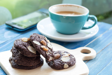 Chocolate cookie on wooden with a cup background