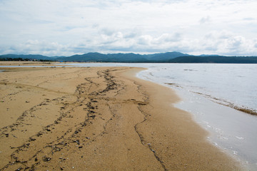 Sandy sea shore in time of low tide.