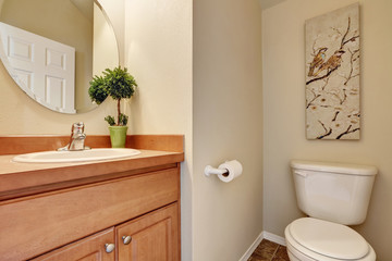 Half bathroom interior with a toilet and small vanity cabinet.
