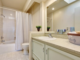 Soft creamy tones  bathroom with tile floor